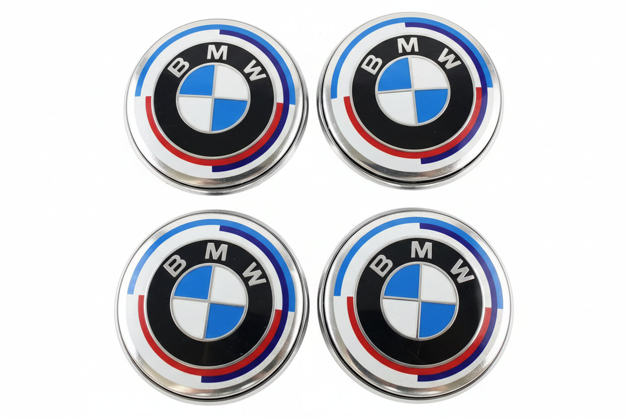 Four BMW emblems on a textured surface